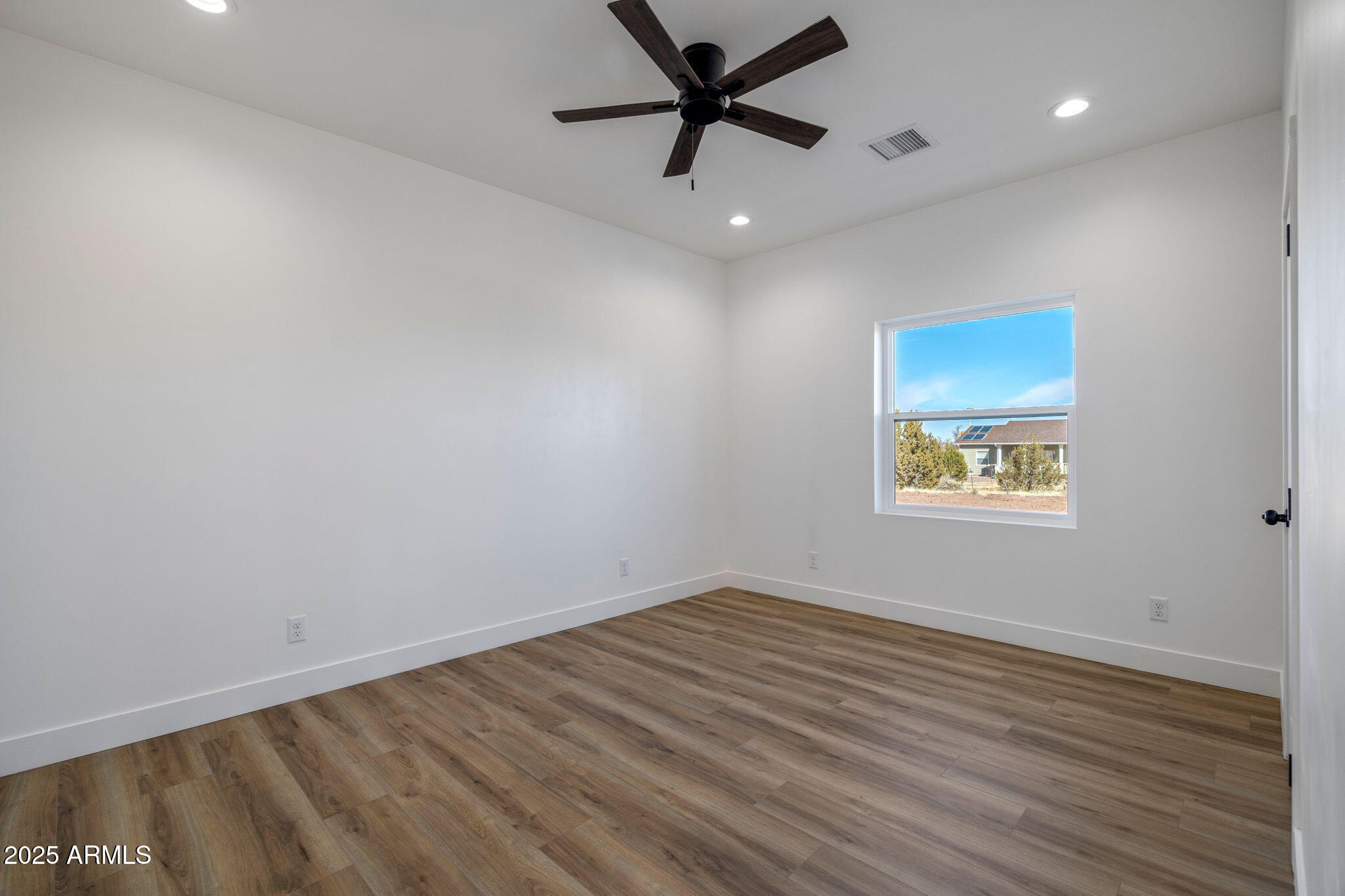 855 10th South St. Johns, AZ 85936 - Photo 29 of 41 an empty room with a window and a ceiling fan