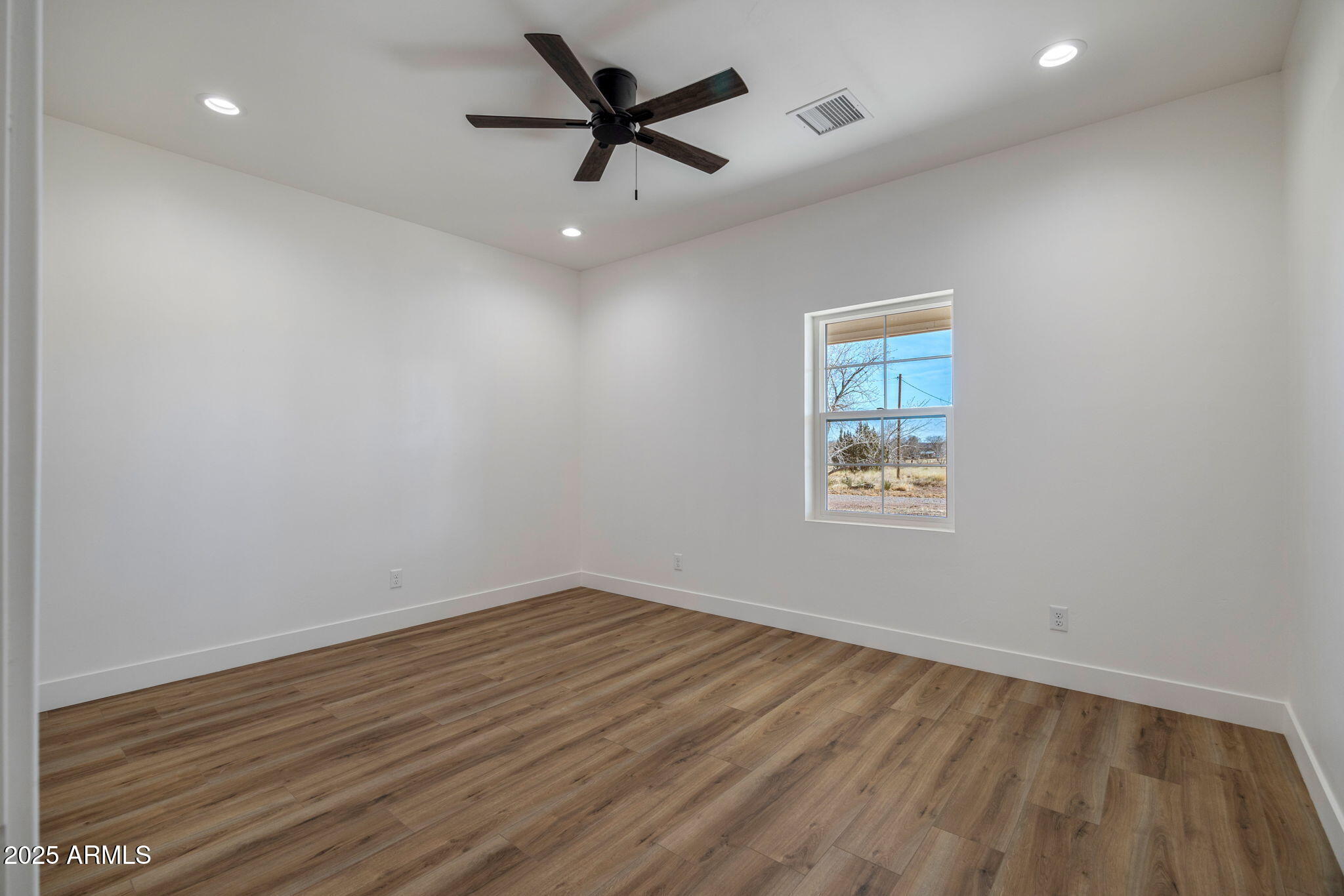 855 10th South St. Johns, AZ 85936 - Photo 32 of 41 an empty room with a window and a ceiling fan