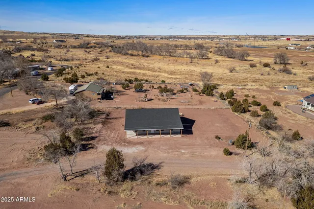 an aerial view of a house with a yard