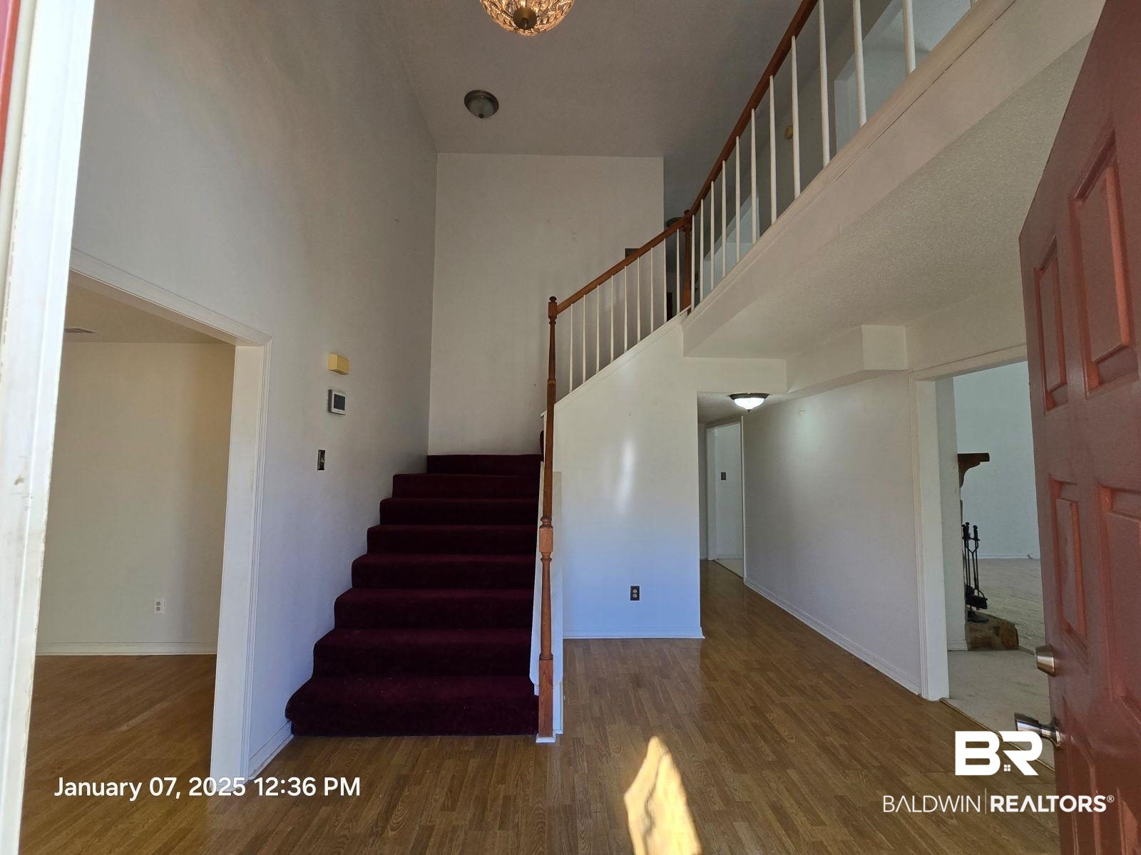 154 Byrd Road Monroeville, AL 36460 - Photo 3 of 26 Stairs with wood-type flooring and a high ceiling