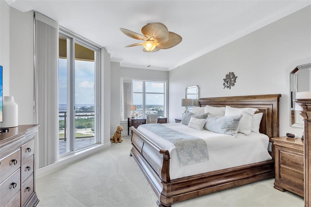 140 Riviera Dunes Way, Unit 1203 Palmetto, FL 34221 - Photo 11 of 30 a bedroom with a bed and a large window