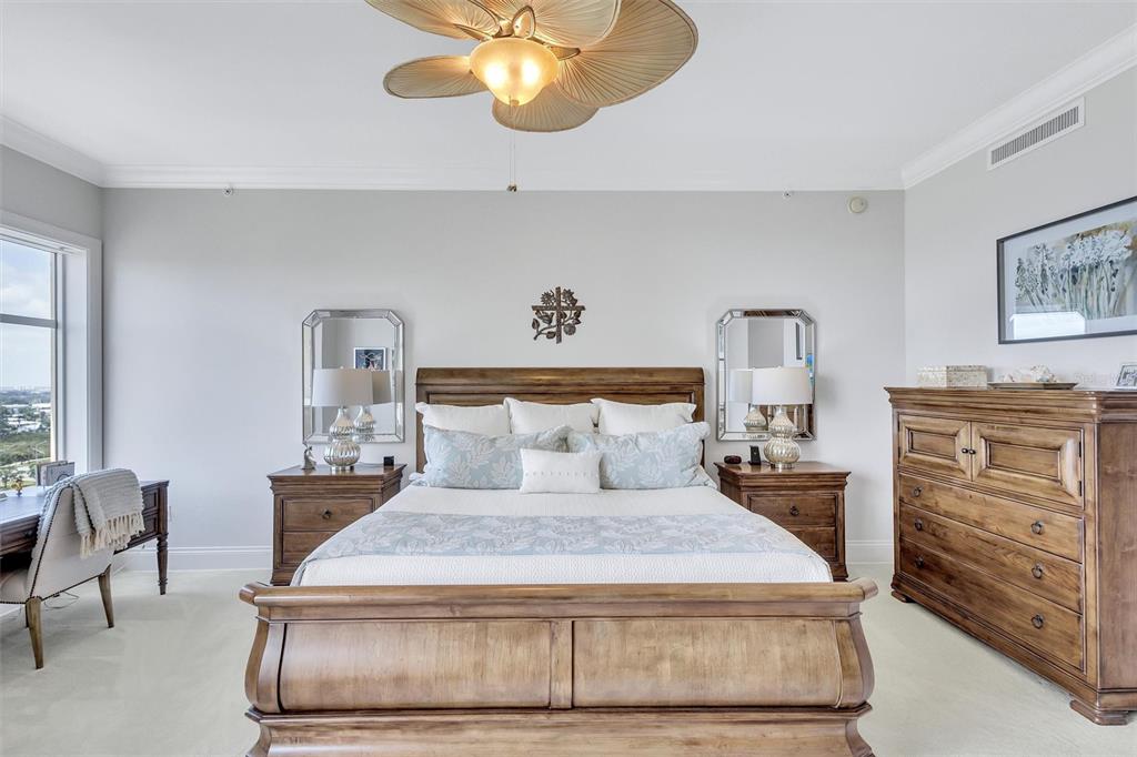 140 Riviera Dunes Way, Unit 1203 Palmetto, FL 34221 - Photo 12 of 30 a bedroom with a bed and wooden floor