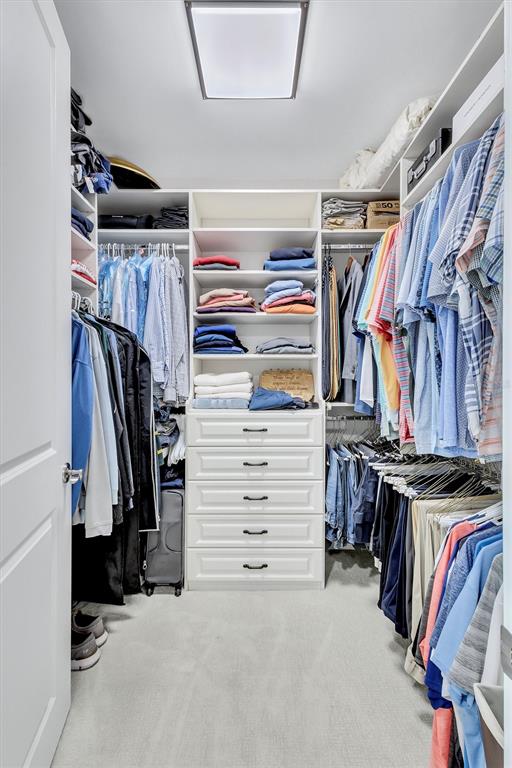 140 Riviera Dunes Way, Unit 1203 Palmetto, FL 34221 - Photo 13 of 30 a view of walk in closet with clothes and shoes