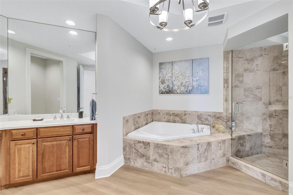 140 Riviera Dunes Way, Unit 1203 Palmetto, FL 34221 - Photo 15 of 30 a bathroom with a tub a sink and mirror