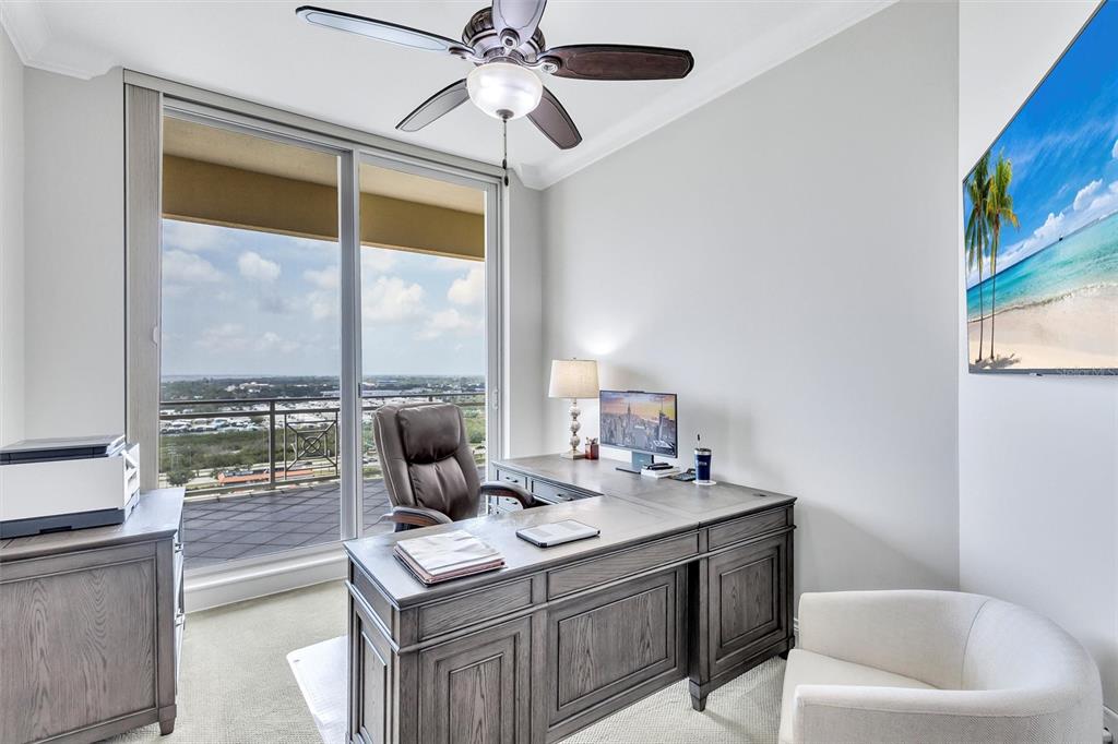 140 Riviera Dunes Way, Unit 1203 Palmetto, FL 34221 - Photo 17 of 30 a living room with furniture and a floor to ceiling window