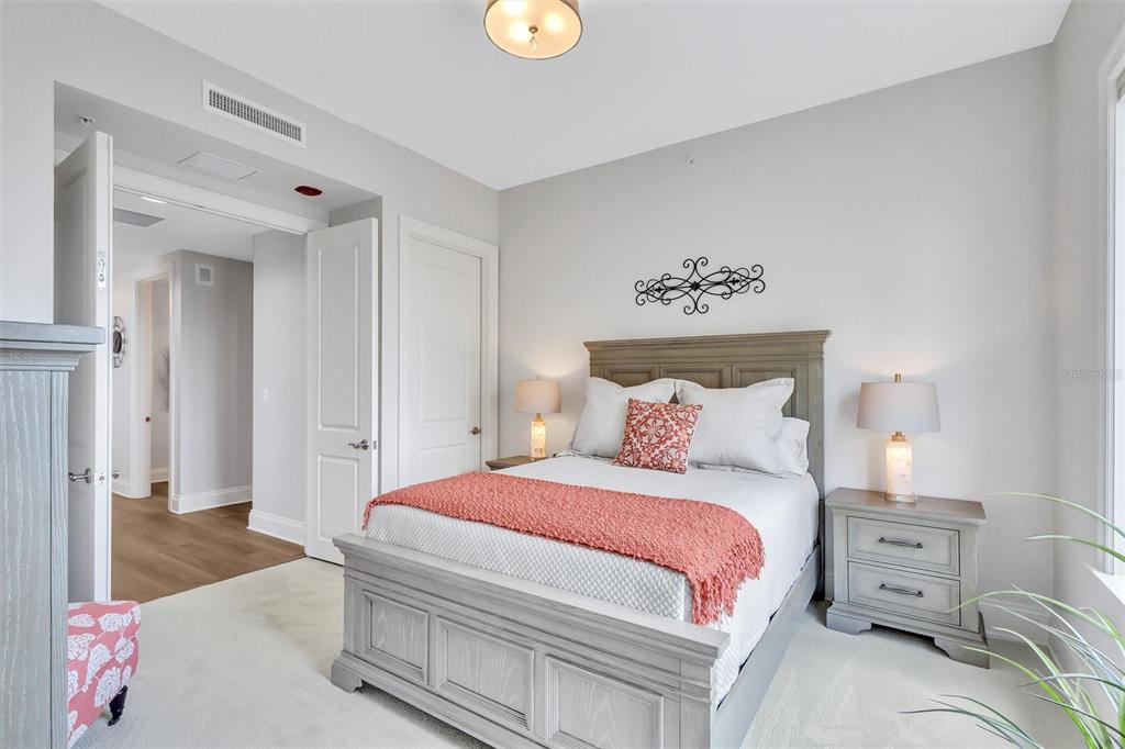 140 Riviera Dunes Way, Unit 1203 Palmetto, FL 34221 - Photo 19 of 30 a bedroom with a bed and a couch
