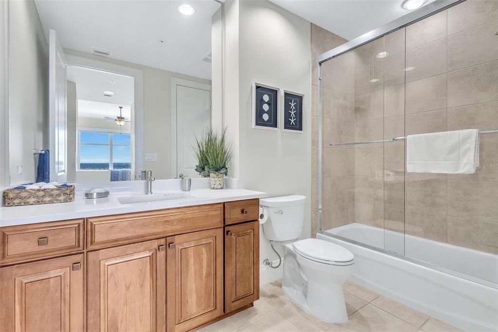 140 Riviera Dunes Way, Unit 1203 Palmetto, FL 34221 - Photo 21 of 30 a bathroom with a sink a toilet and shower