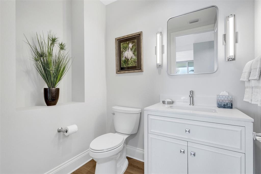 140 Riviera Dunes Way, Unit 1203 Palmetto, FL 34221 - Photo 23 of 30 a bathroom with a toilet sink and mirror