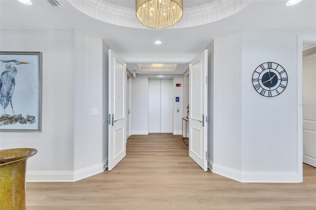 140 Riviera Dunes Way, Unit 1203 Palmetto, FL 34221 - Photo 3 of 30 a view of a hallway with wooden floor