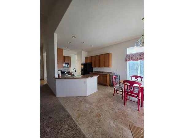 a living room with furniture and kitchen view