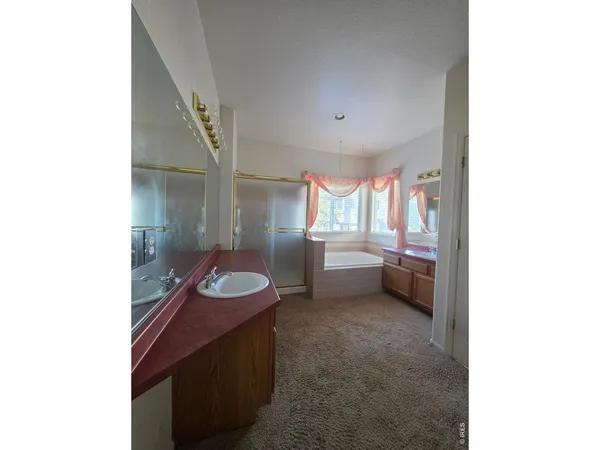 a spacious bathroom with a double vanity sink and a mirror