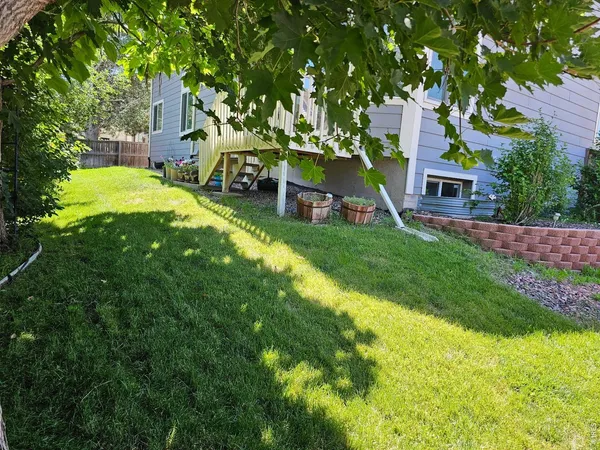 a view of house with a yard