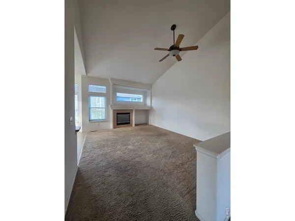 a view of empty room with a fireplace