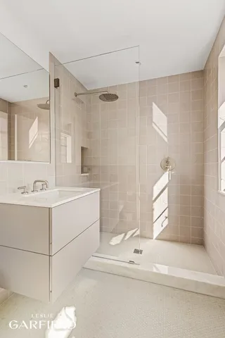 a bathroom with a sink mirror and a bathtub