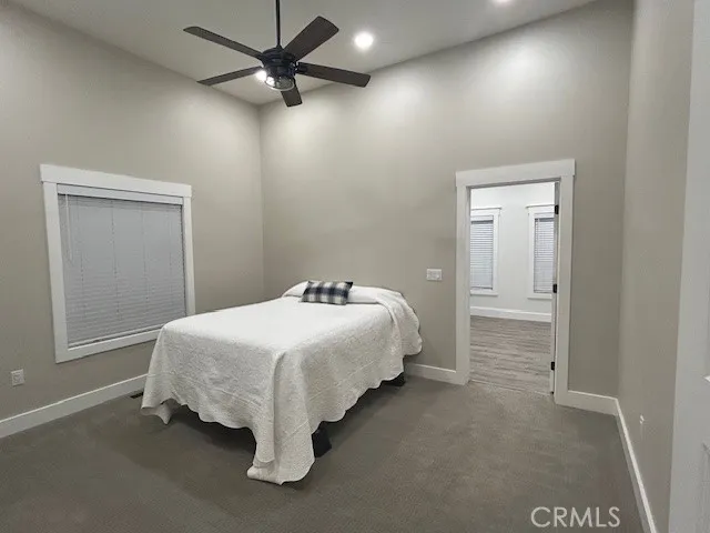 a spacious bedroom with a bed and a chandelier