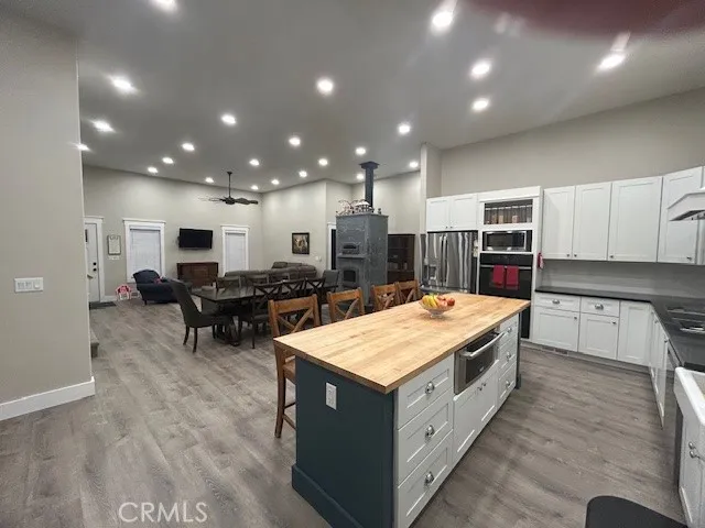 a large kitchen with kitchen island a sink table and chairs