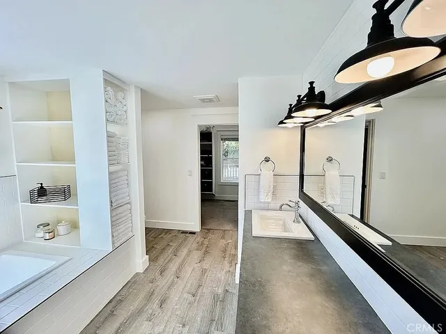 a view of hallway with stairs and wooden floor