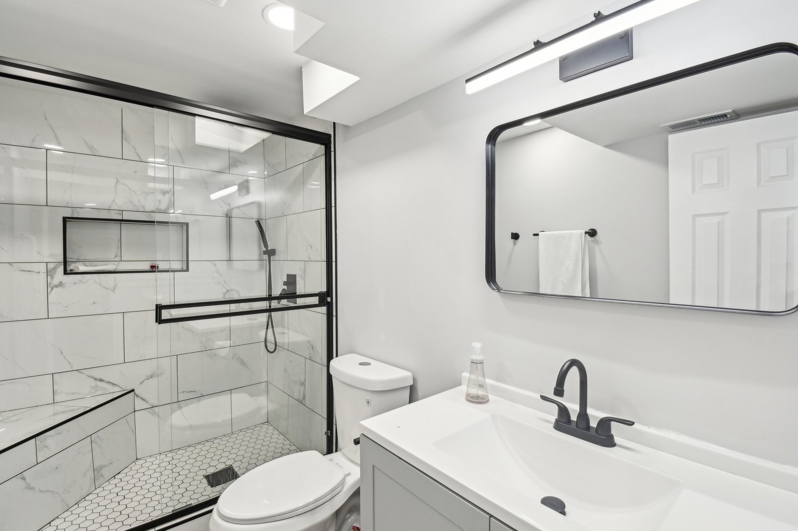 703 Sunset Circle Streamwood, IL 60107 - Photo 13 of 22 a bathroom with a sink a toilet and shower