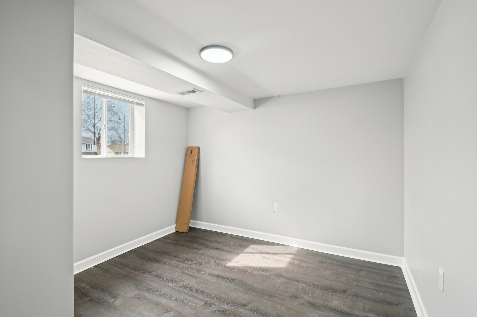703 Sunset Circle Streamwood, IL 60107 - Photo 15 of 22 an empty room with wooden floor and windows