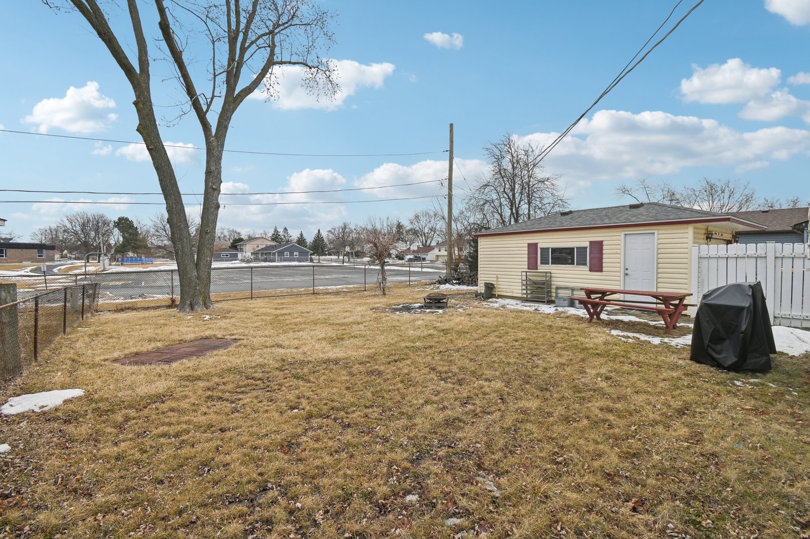 703 Sunset Circle Streamwood, IL 60107 - Photo 17 of 22 a view of a house with backyard and a tree