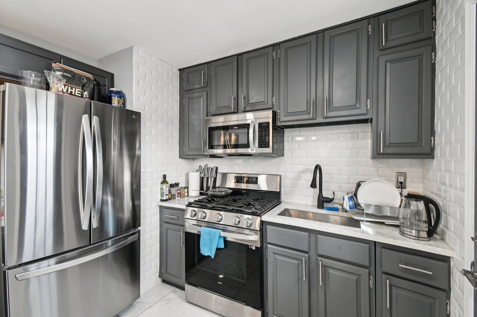 703 Sunset Circle Streamwood, IL 60107 - Photo 5 of 22 a kitchen with stainless steel appliances granite countertop a refrigerator stove and sink