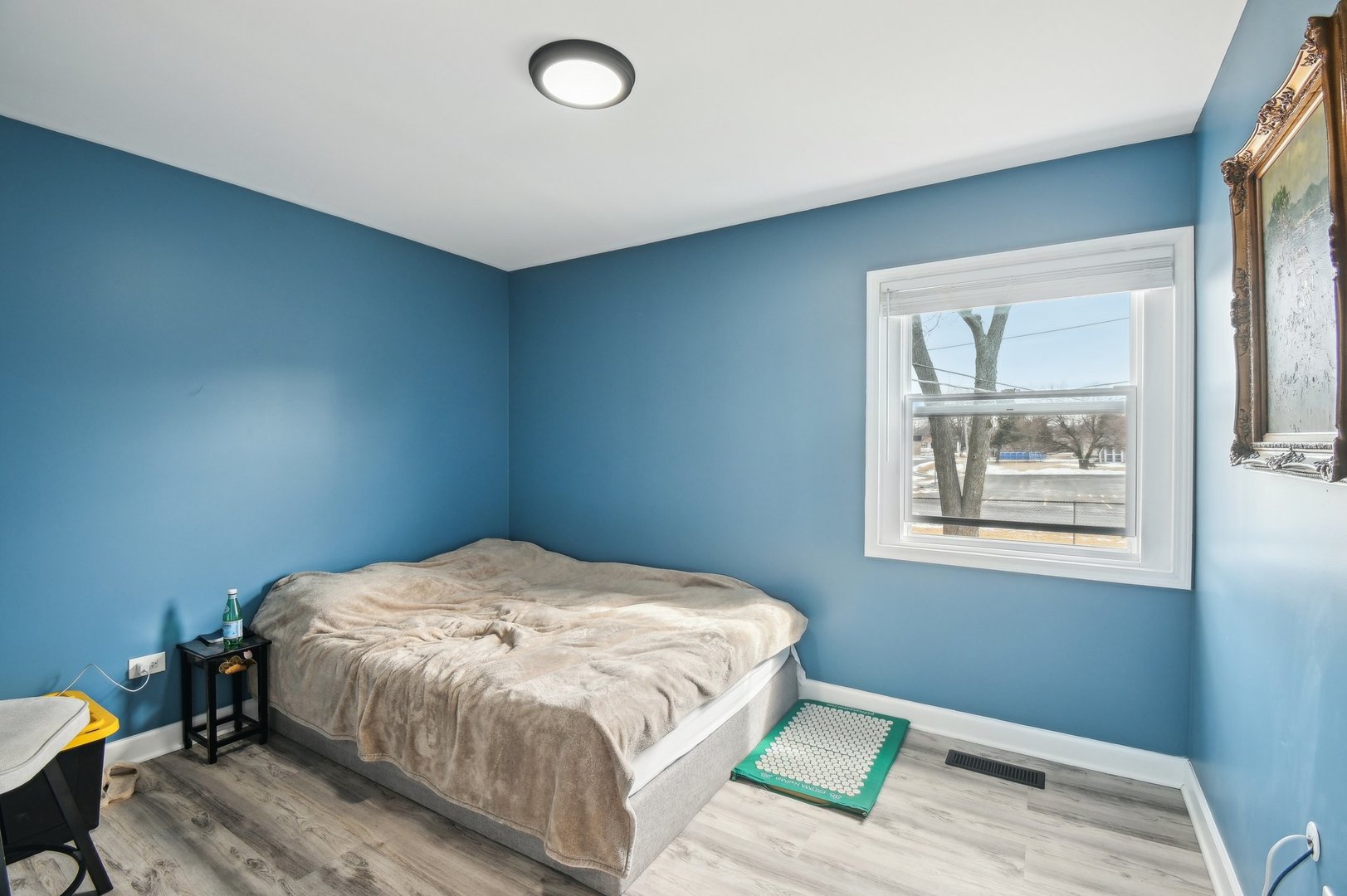 703 Sunset Circle Streamwood, IL 60107 - Photo 7 of 22 a bedroom with a bed and a window