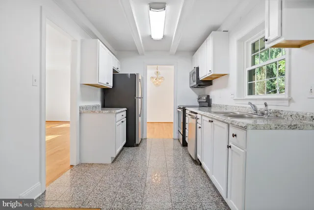 a kitchen with a sink stove and refrigerator