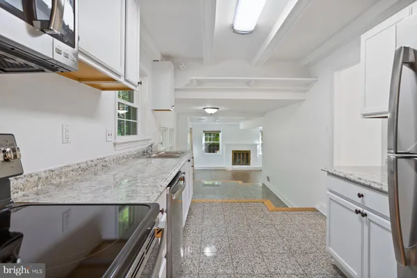 a kitchen with a table and chairs