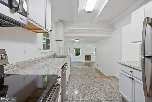 a kitchen with a table and chairs