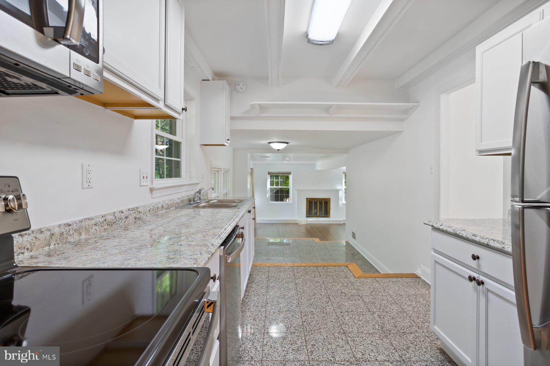 1242 Derbyshire Road Potomac, MD 20854 - Photo 15 of 40 a kitchen with a table and chairs