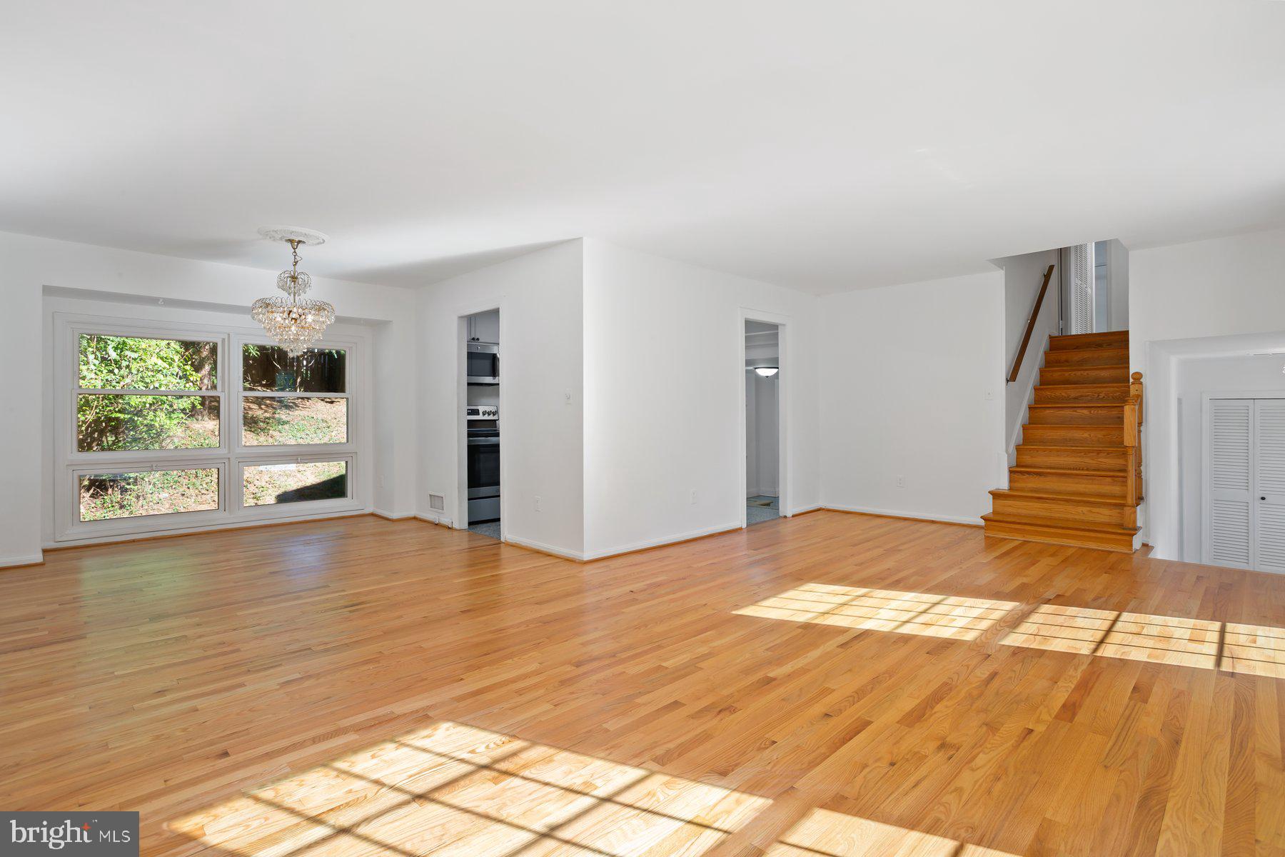 1242 Derbyshire Road Potomac, MD 20854 - Photo 17 of 40 a view of an empty room with wooden floor and a window