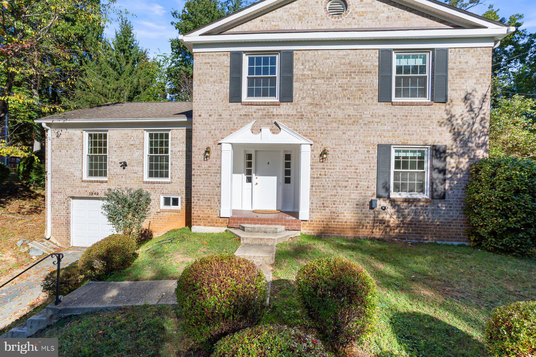 1242 Derbyshire Road Potomac, MD 20854 - Photo 2 of 40 front view of a house with a yard