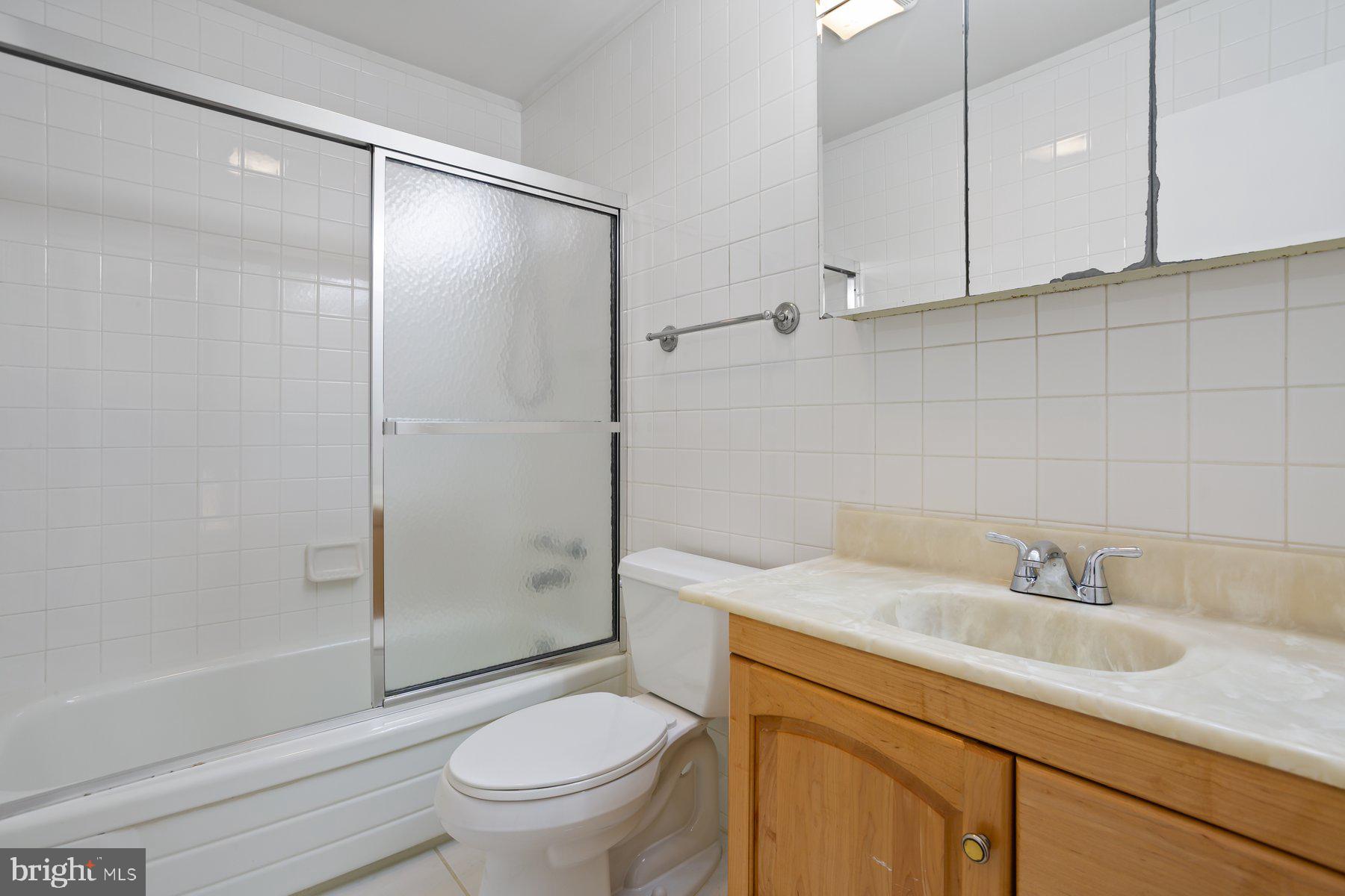 1242 Derbyshire Road Potomac, MD 20854 - Photo 27 of 40 a bathroom with a sink toilet and shower