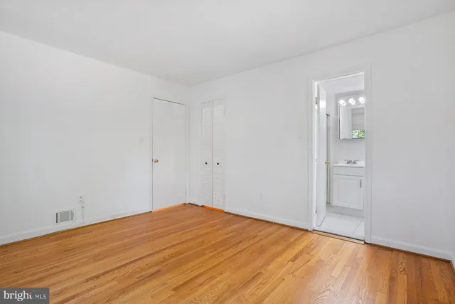 a bathroom with a toilet a sink and a mirror