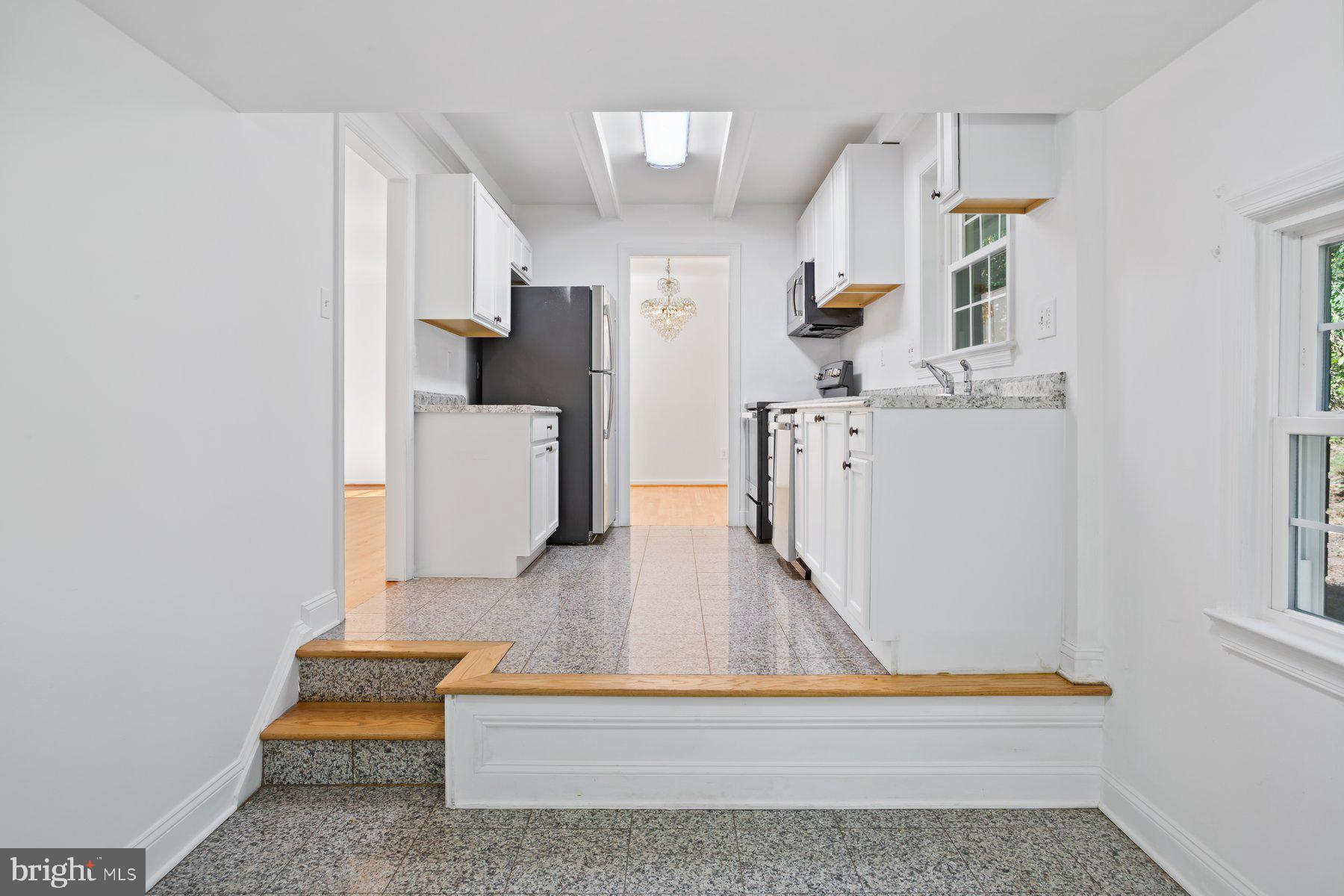 1242 Derbyshire Road Potomac, MD 20854 - Photo 6 of 40 a living room with furniture and a wooden floor