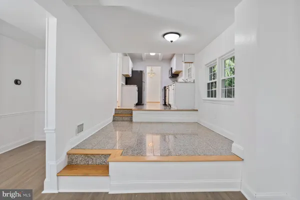 a view of entryway and hall with wooden floor