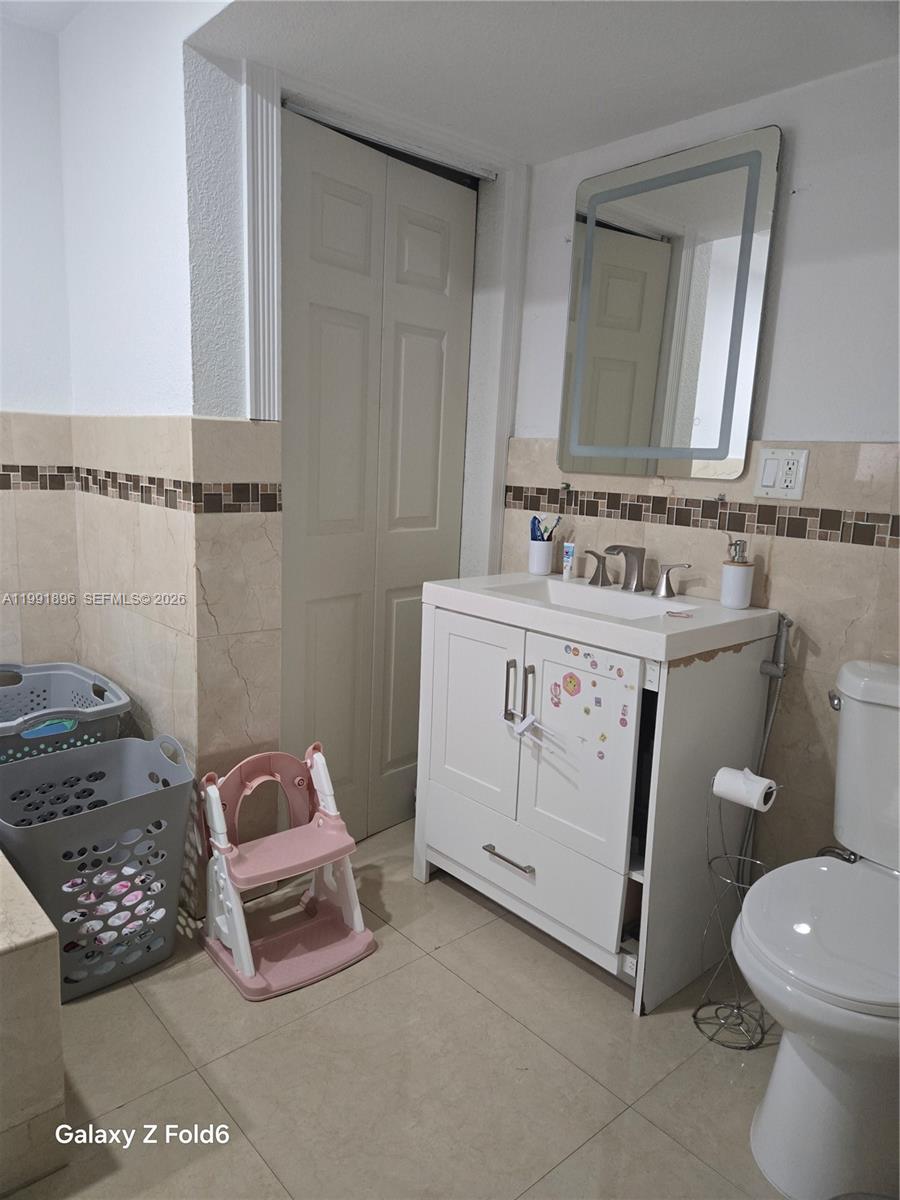 234 East 44th Street Hialeah, FL 33013 - Photo 12 of 14 a bathroom with a sink toilet and mirror