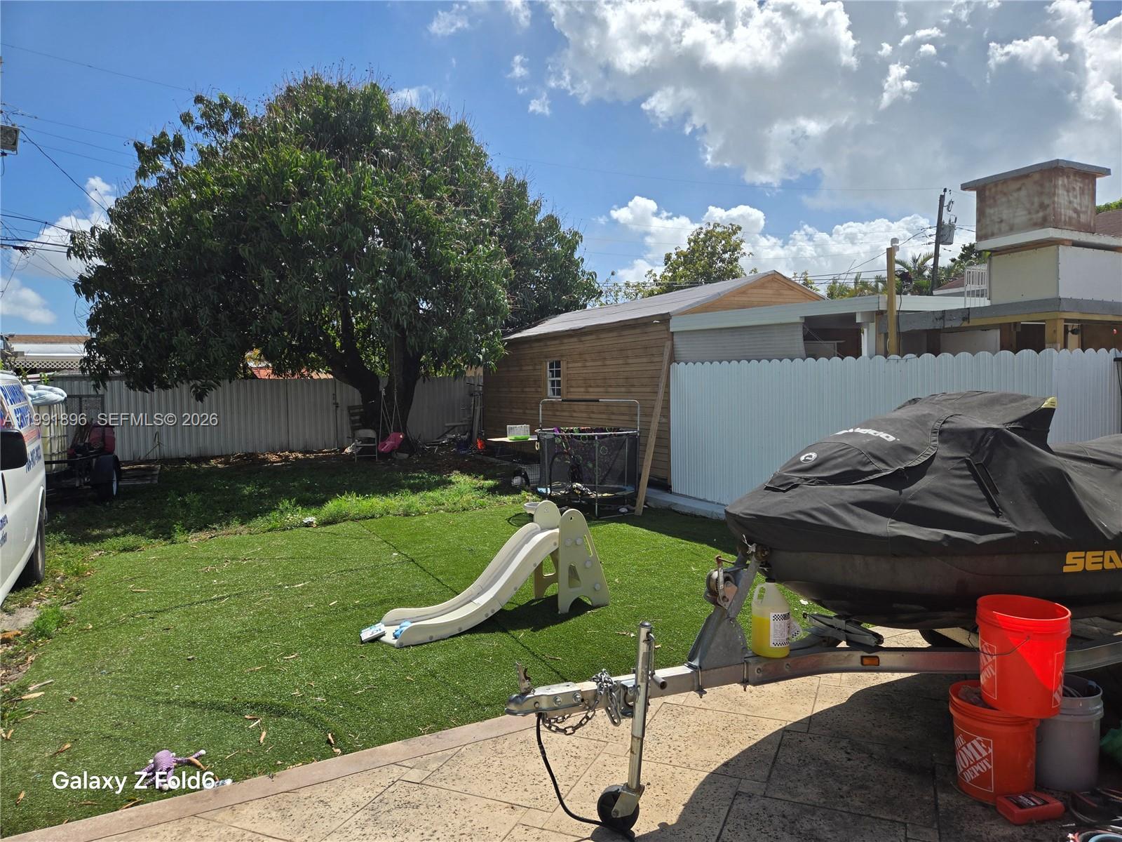 234 East 44th Street Hialeah, FL 33013 - Photo 13 of 14 a view of a backyard with plants and a fire pit