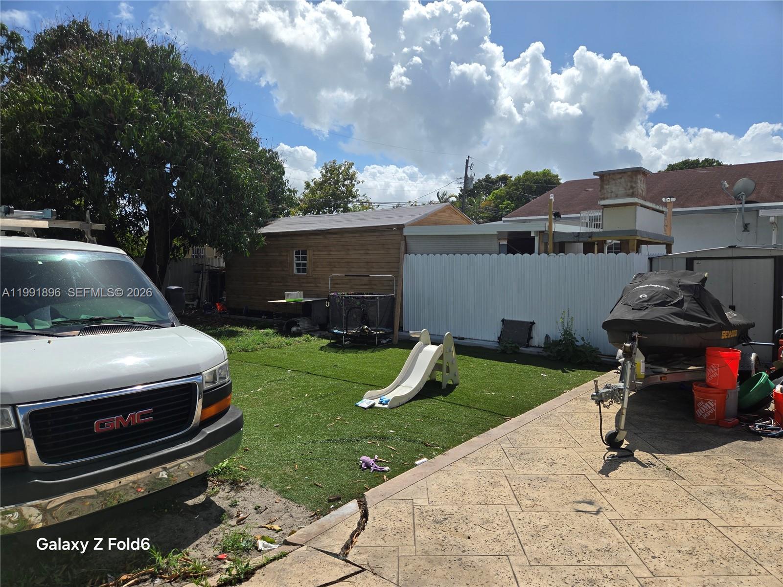 234 East 44th Street Hialeah, FL 33013 - Photo 14 of 14 a view of a backyard with couches under an umbrella