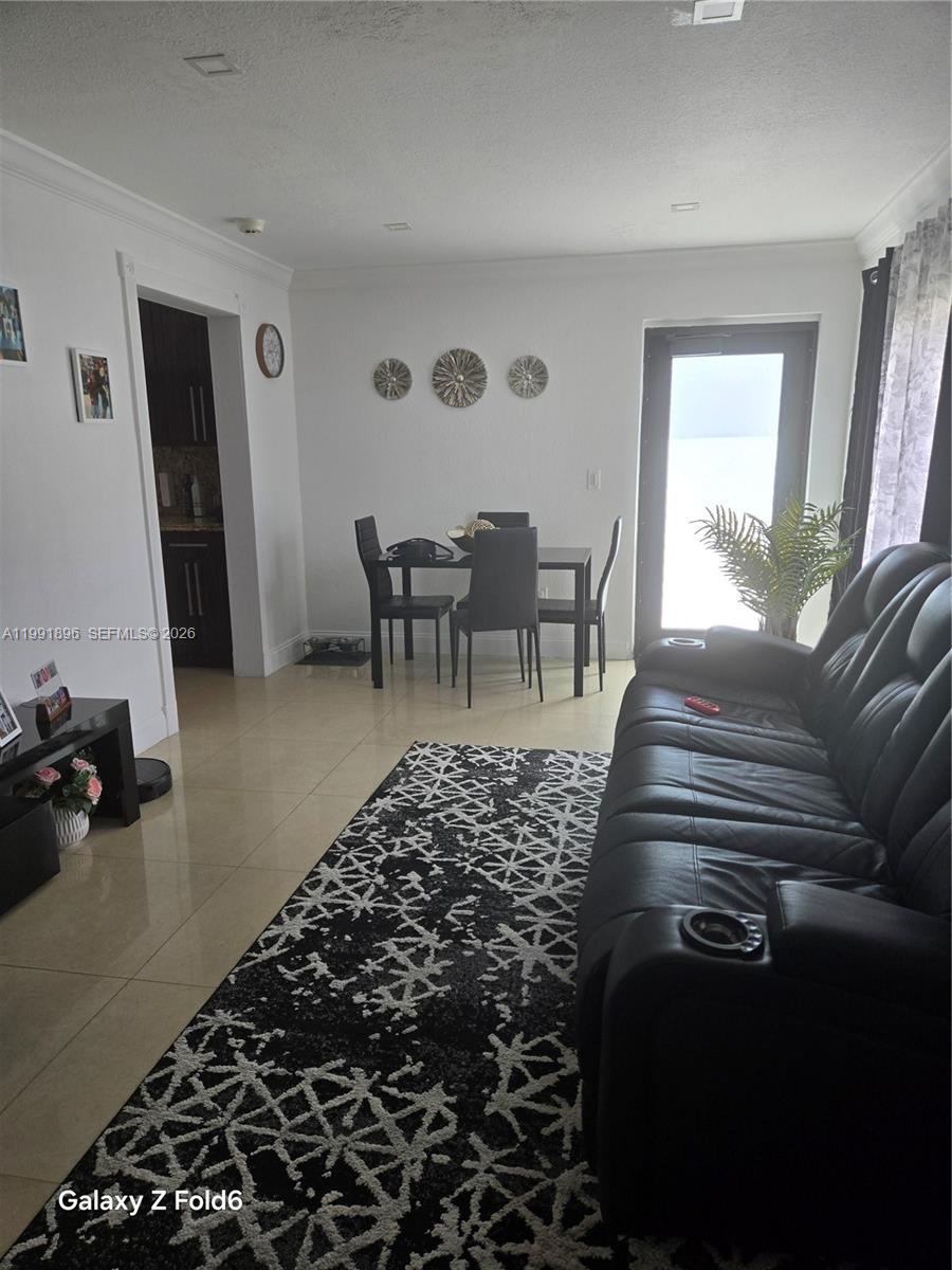 234 East 44th Street Hialeah, FL 33013 - Photo 3 of 14 a living room with furniture a rug and a window