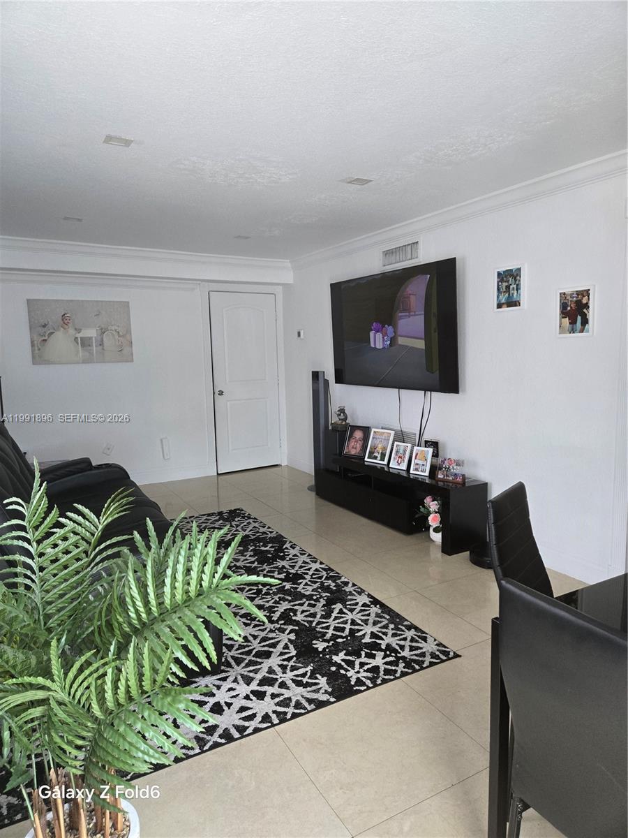 234 East 44th Street Hialeah, FL 33013 - Photo 4 of 14 a living room with furniture and a flat screen tv