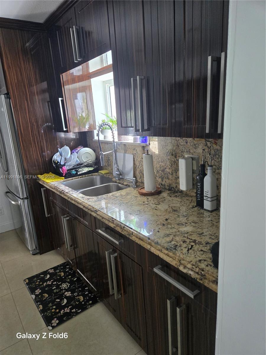 234 East 44th Street Hialeah, FL 33013 - Photo 7 of 14 a kitchen with a sink a stove and cabinets