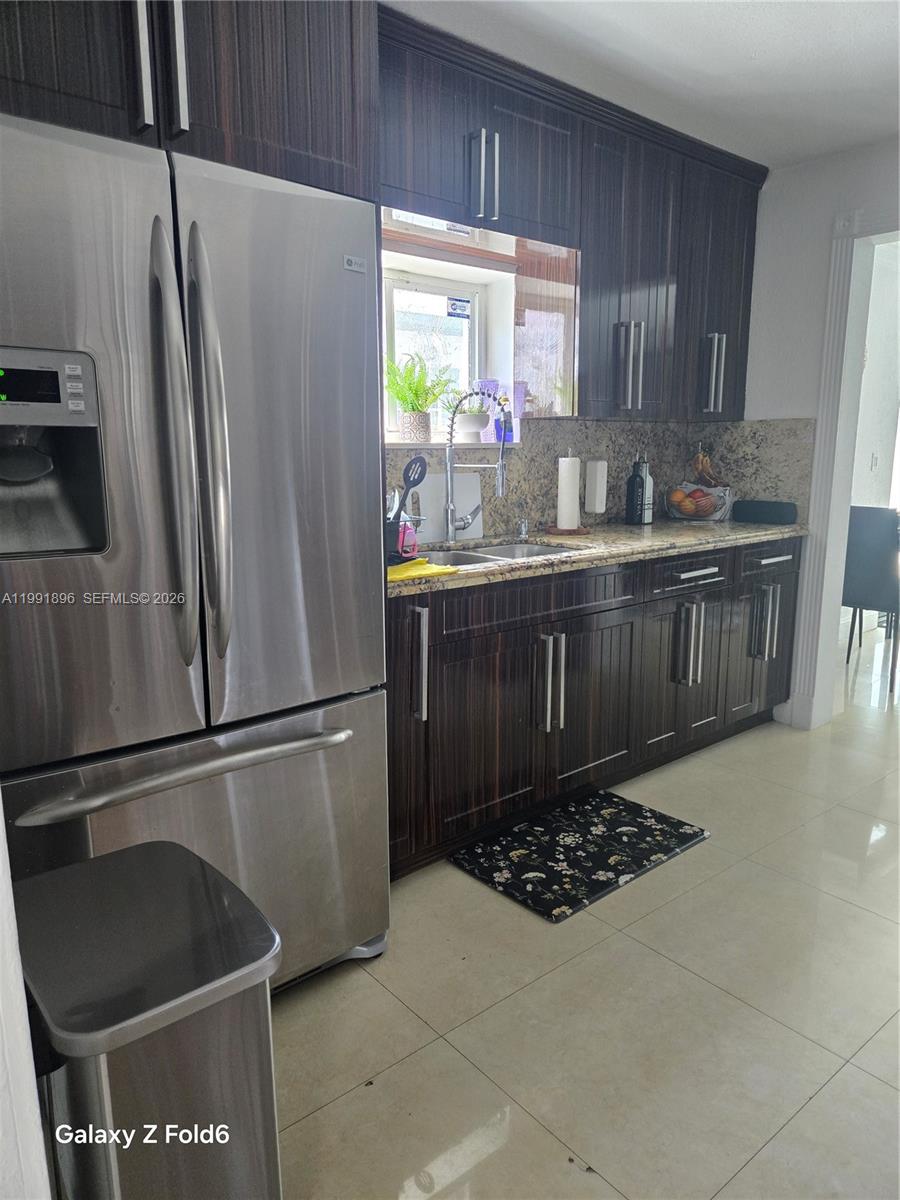 234 East 44th Street Hialeah, FL 33013 - Photo 8 of 14 a kitchen with stainless steel appliances granite countertop a refrigerator and a sink