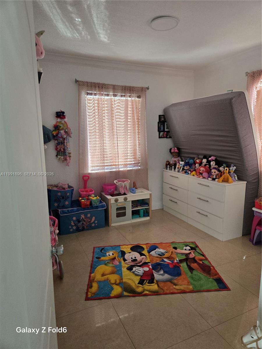 234 East 44th Street Hialeah, FL 33013 - Photo 9 of 14 a bedroom with lots of baby toys