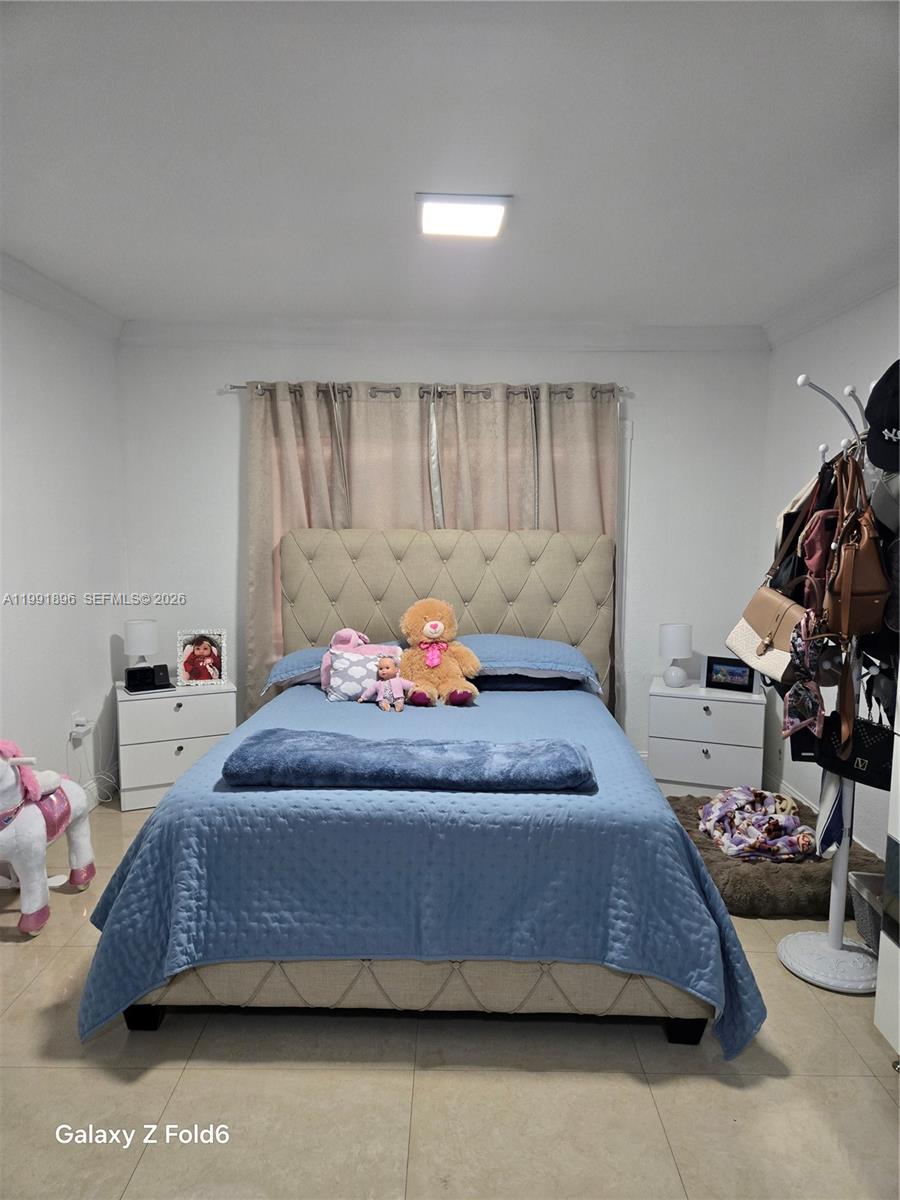 234 East 44th Street Hialeah, FL 33013 - Photo 10 of 14 a bedroom with a bed and a couch