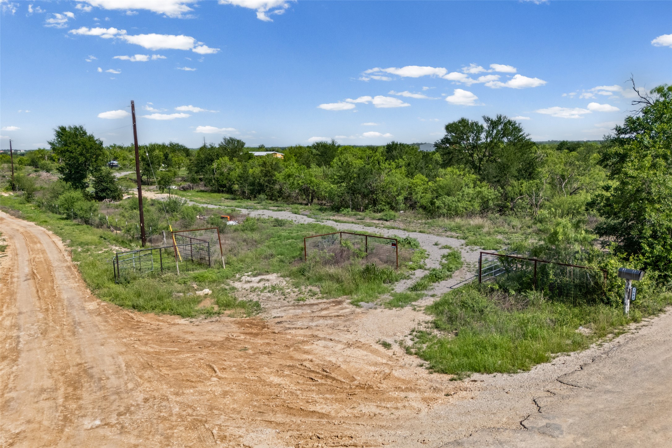 3882 Dry Creek Road Lockhart, TX 78644 - Photo 32 of 34 Expansive undeveloped land featuring a private gated entrance and varied terrain