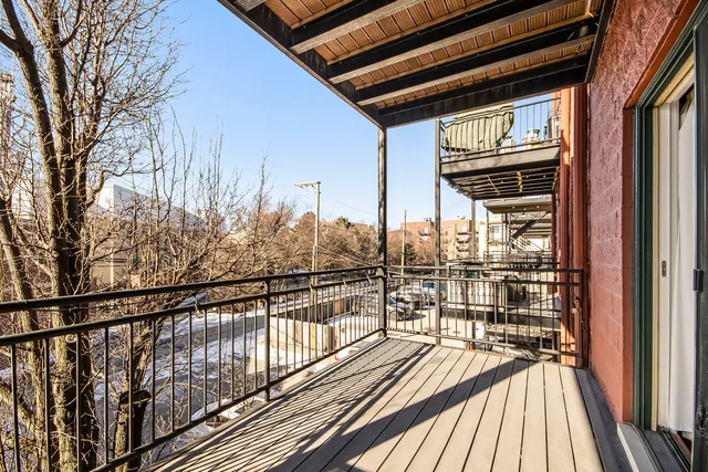 a view of balcony and deck with wooden floor and fence