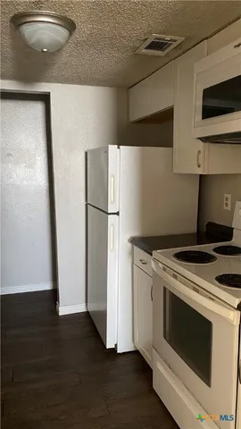 a stove top oven sitting inside of a kitchen