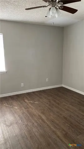 a view of a room with wooden floor