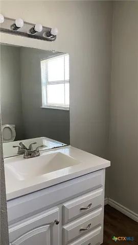 a bathroom with a sink and a window